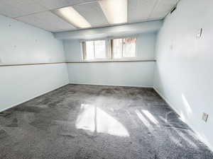 Carpeted empty room with a paneled ceiling