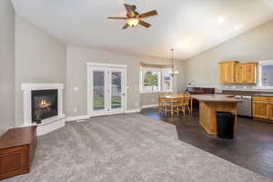 Open-concept living room, dining area, kitchen, and backdoor. Features fireplace and natural light.