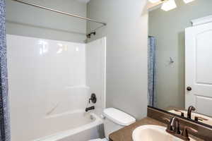 Second, upstairs full bathroom with toilet, shower / bath combination with curtain, and vanity