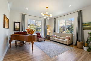 Sitting room featuring light hardwood / wood-style flooring, a chandelier, and a wealth of natural light