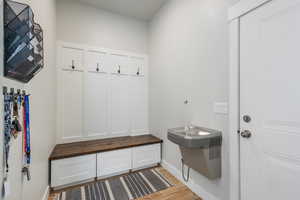 Mudroom with light hardwood / wood-style flooring