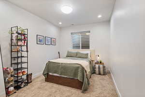 Carpeted bedroom with a textured ceiling