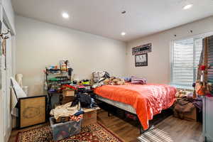 Bedroom with hardwood / wood-style flooring