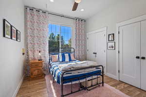 Bedroom featuring wood-type flooring and ceiling fan