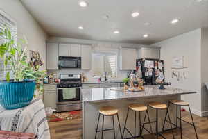 ADU Kitchen with a kitchen island, black appliances, and a wealth of natural light