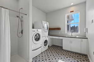 Laundry room featuring sink and light tile patterned floors