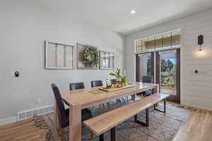 Dining space with hardwood / wood-style flooring