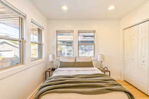 Main level bedroom #1 with bamboo flooring and a walk-in closet