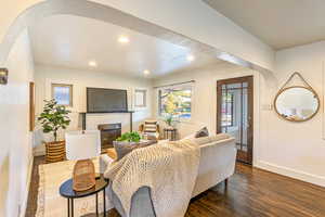 Main level living room featuring a fireplace and dark wood flooring