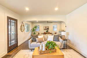 Main level living/dining room featuring dark hardwood flooring and ceiling fan