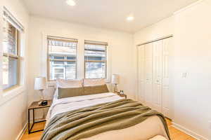 Main level bedroom #1 with bamboo flooring and a walk-in closet