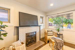 Main level living area with hardwood flooring and a fireplace