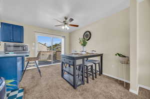 Dining area featuring ceiling fan and carpet