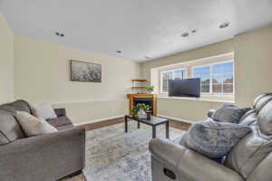 Living room featuring a textured ceiling and light colored carpet