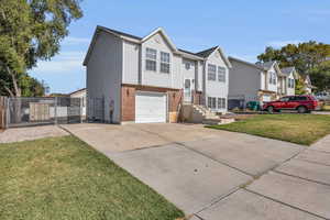 View of front facade with a front lawn and a garage