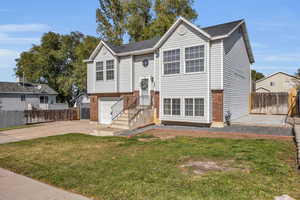 Split foyer home featuring a front lawn