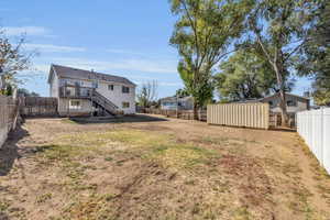 View of yard with a shed and a deck