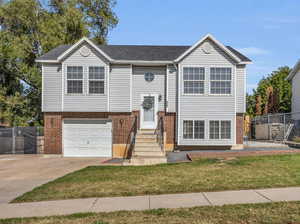 Raised ranch with a garage and a front lawn