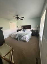 Carpeted bedroom with a closet and ceiling fan