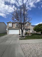 View of front facade with a garage and a front yard