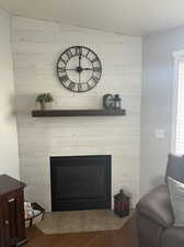 Interior details featuring hardwood / wood-style flooring, a fireplace, and a textured ceiling