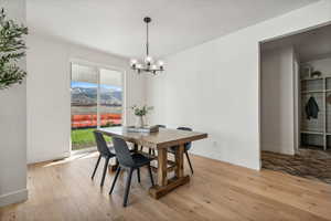 Dining area featuring an inviting chandelier and mountain views