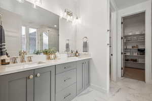 Bathroom with vanity and a shower with shower door