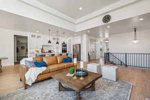 Living room with light hardwood / wood-style flooring and sink