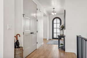 Foyer with an inviting chandelier and light hardwood / wood-style floors