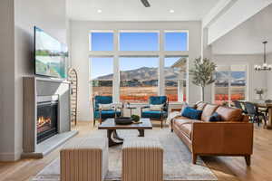 Living room with light hardwood and a wealth of natural light