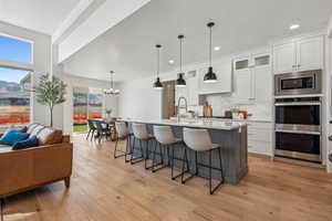 Kitchen with a healthy amount of sunlight, decorative light fixtures, double oven