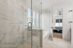 Bathroom featuring plus walk in shower and elegant tile