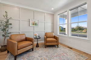 Sitting room or office with crown molding and light wood-type flooring