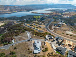 Birds eye view of property with a water and mountain view