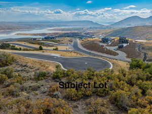 Birds eye view of property with a water and mountain view