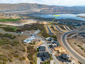 Drone / aerial view featuring a water and mountain view