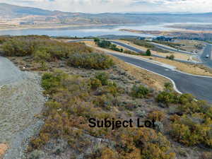 Birds eye view of property featuring a water and mountain view