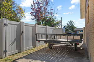 Level concrete RV Pad continuous with driveway. Double wide gate for easy access.