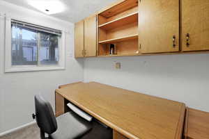 Dedicated home office with built in cabinets and wood desk.