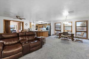 Open layout family room with large windows located next to dining area.