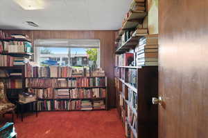 Spacious library with classic wood paneling and built-in shelving. Don’t miss the “hidden” closet.