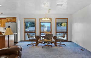 Open floor plan includes dining space with large windows.