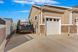 View of side of home featuring a garage