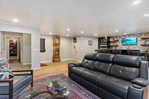 Living room featuring bar and light hardwood / wood-style floors