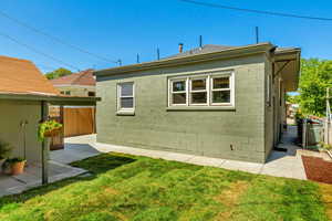 Back of property featuring a lawn and a patio area