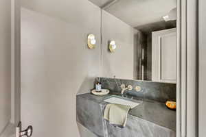 Bathroom with decorative backsplash and vanity