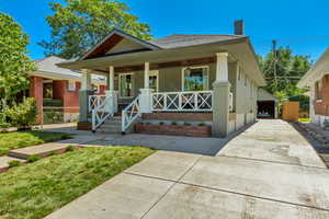 Bungalow featuring a front lawn and a porch