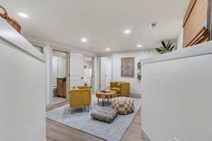 Sitting room with light hardwood / wood-style flooring