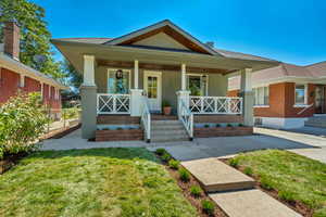 Bungalow-style house featuring a front lawn and covered porch