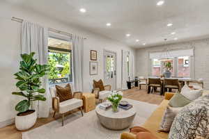 Living room with light hardwood / wood-style floors and plenty of natural light